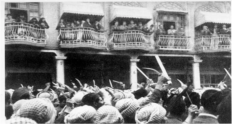 Arab nationalists raise knives in the air during the Farhud